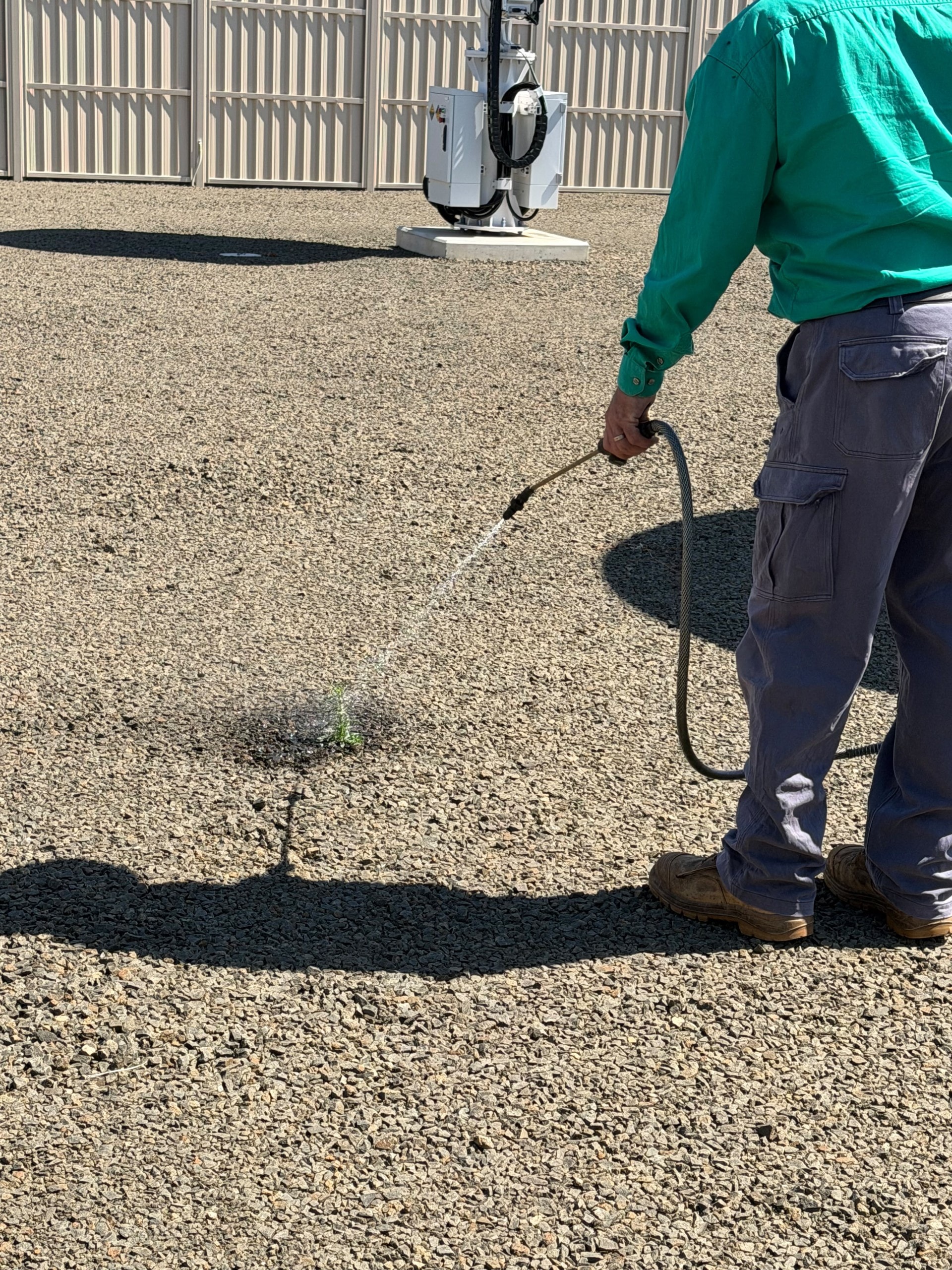 Weed spraying close up gravel area